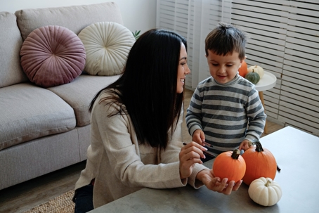 Mom and son making halloween decoration