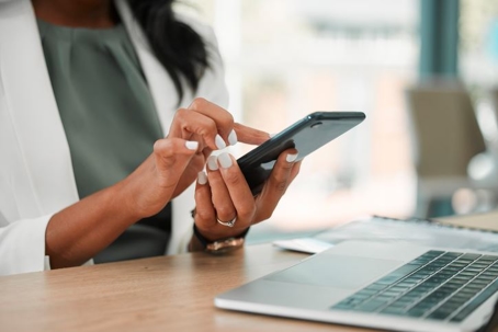 woman typing on smartphone