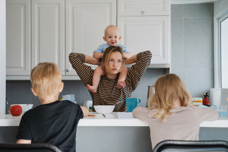 stressed mother with her children at home