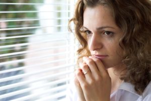 Concerned woman looking out the window